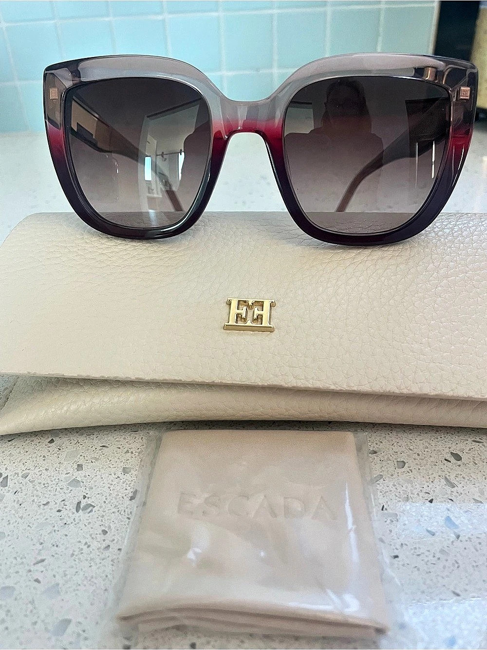 Escada SESD98 sunglasses featuring a burgundy and grey gradient cat-eye frame